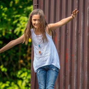 Canva - Young Girl Playing Outdoors